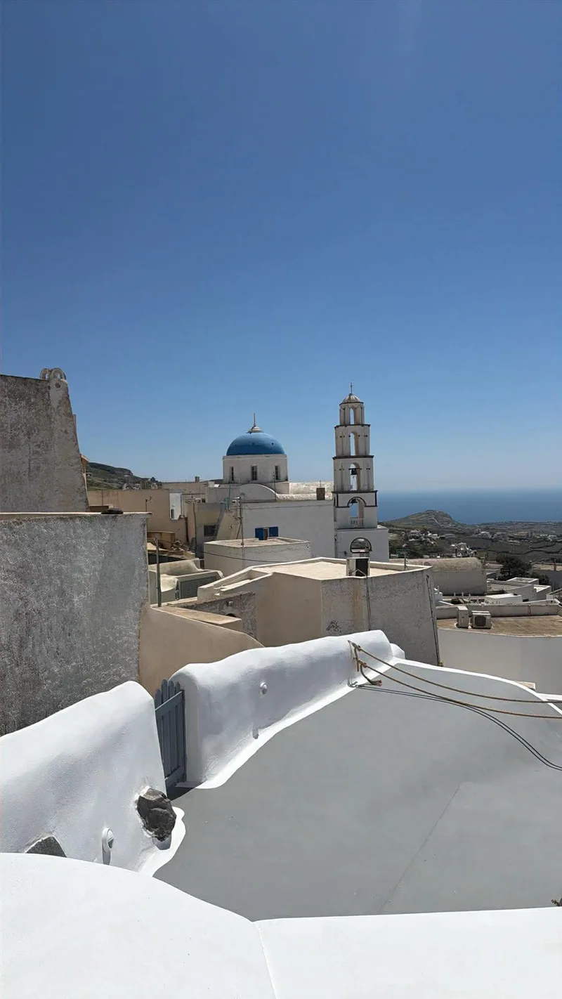 A blue-domed church above the rooftops of Pyrgos village