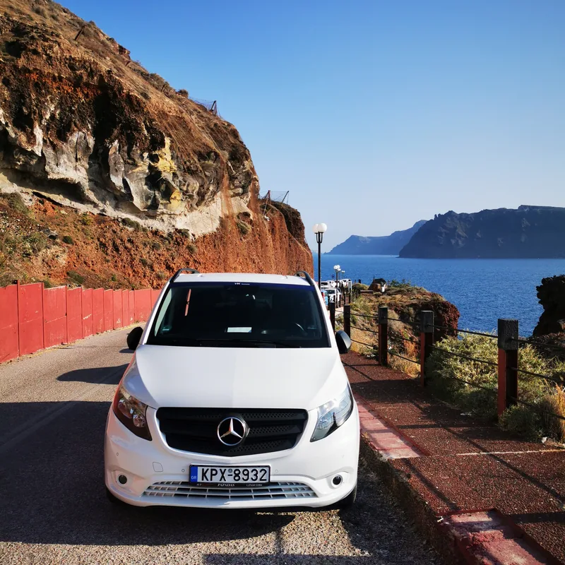 The white Mercedes Vito on the red rock road above the Red Beach