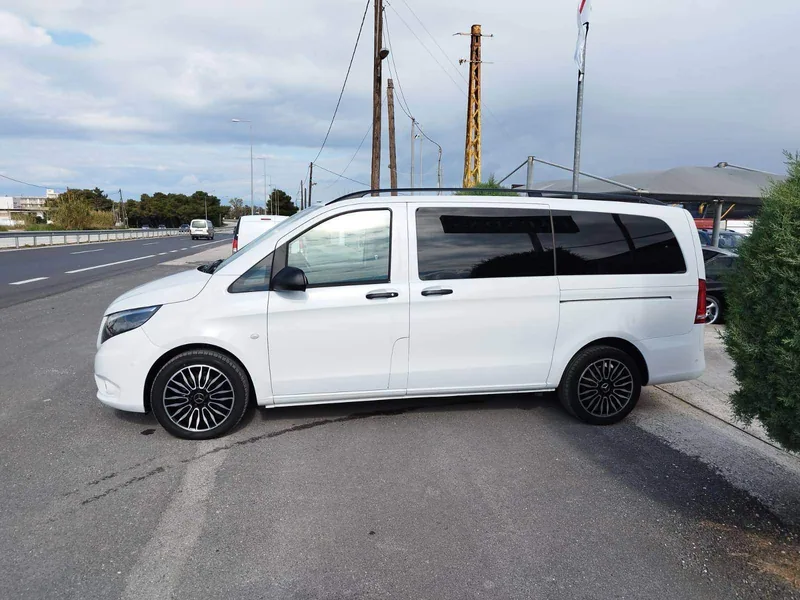 The white Mercedes Vito on the road down to Athinios port, Santorini